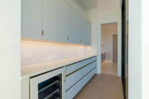 An undercounter refrigerator built into a butler's pantry