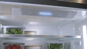 A refrigerator interior control display lit with a short message that cannot be read