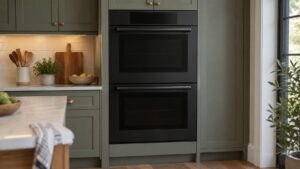 A double wall oven in matte black with its display dark in a kitchen wall